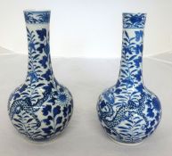 A pair of Chinese blue and white porcelain bottle vases decorated with dragons and flowers, each