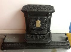 A French ornate iron wood burner stamped Godin and Laeken, Brevete, No.68, height 67cm, together