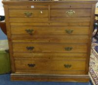 A large Edwardian chest fitted with two short and three short drawers with brass plate handles,