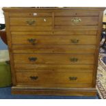 A large Edwardian chest fitted with two short and three short drawers with brass plate handles,