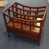 A late Georgian mahogany three division Canterbury, fitted with a single drawer on four ring