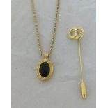 A Christian Dior oval black enamelled pendant and necklace and stick pin in original box.