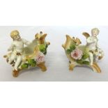 A pair of Victorian porcelain figures of small cherubs and baskets, height 9cm.