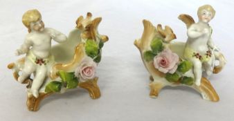 A pair of Victorian porcelain figures of small cherubs and baskets, height 9cm.