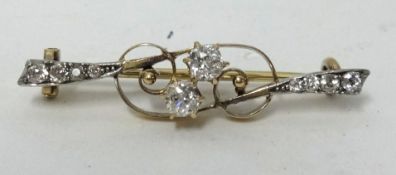 An antique diamond bar brooch set with an arrangement of ten old cut diamonds, length 38mm.