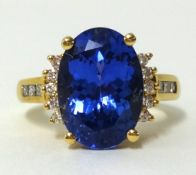 An 18ct large tanzanite and diamond set ring, finger size O.