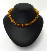An amber pendant and an amber style bead necklace, graduated beads, length 56cm, approx 30.80gms.