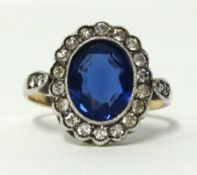 A 9ct white gold sapphire effect cluster ring, finger size P.