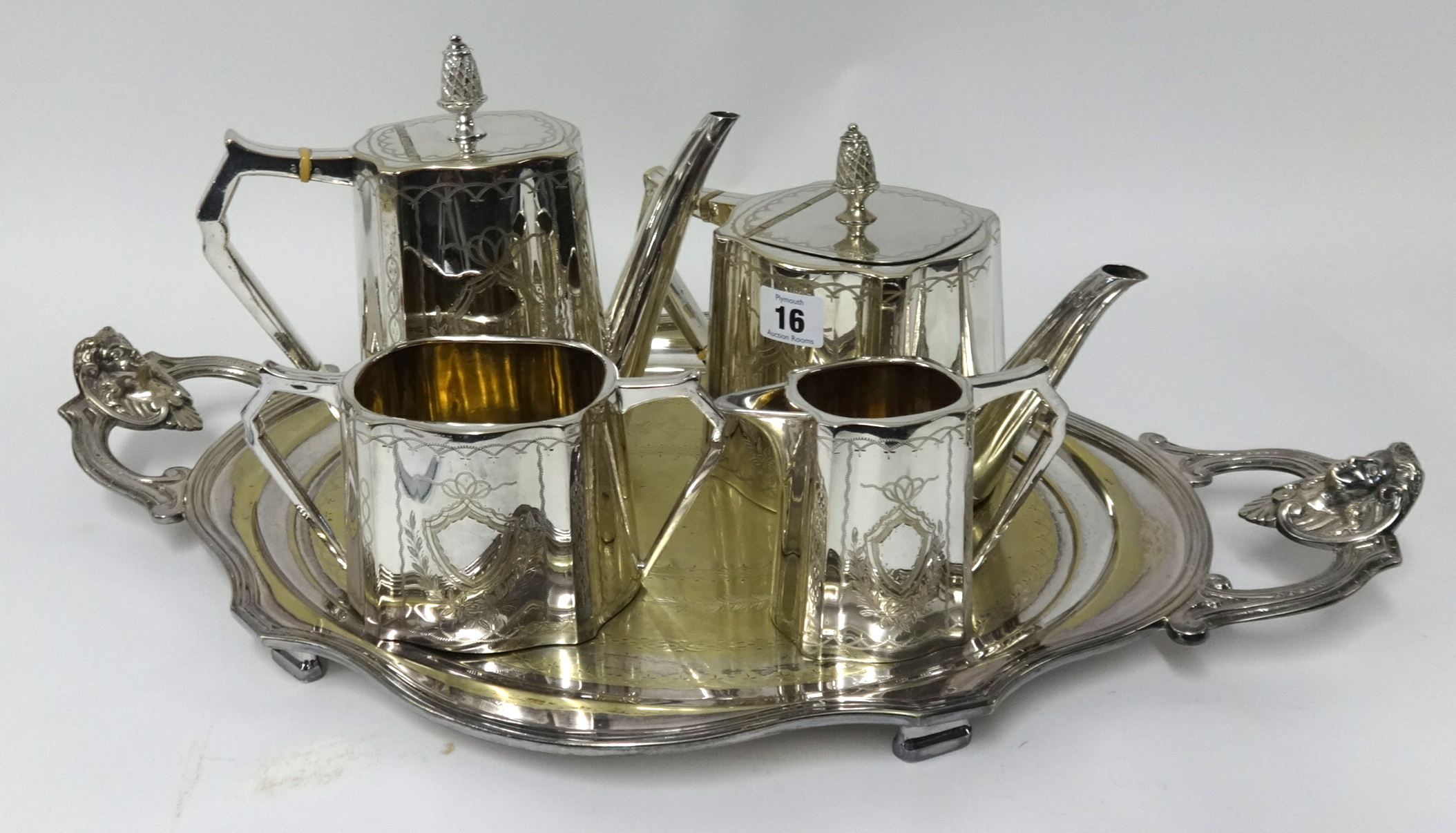 Silver plated four piece tea service with pineapple finials and a silver plated serving tray with