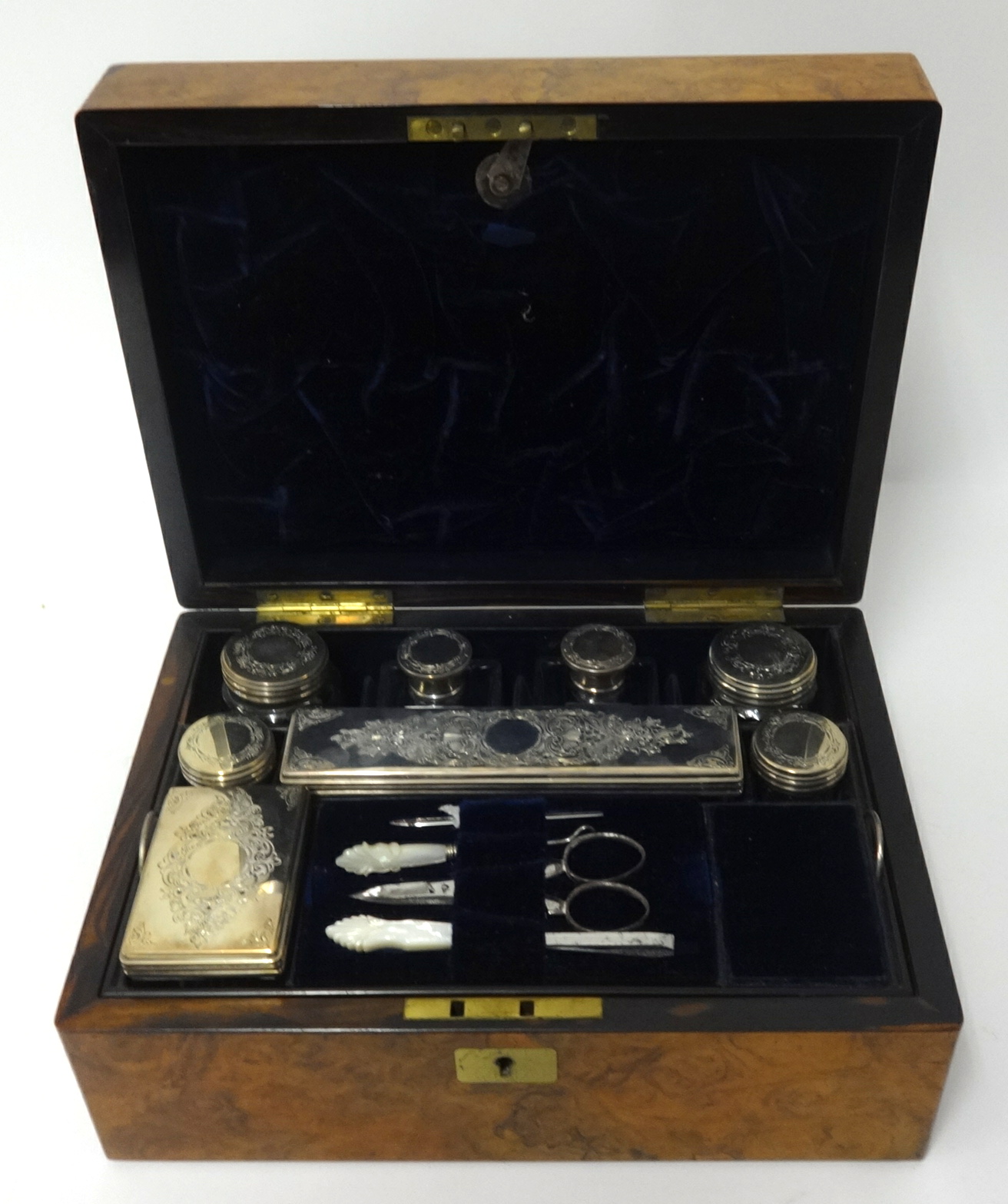 A Victorian ladies travel toilet box with fitted interior with an arrangement of eight bottles and