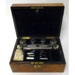 A Victorian ladies travel toilet box with fitted interior with an arrangement of eight bottles and