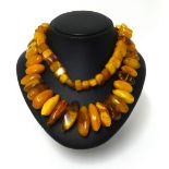 An amber necklace, approx 45cm long, various cuts, weight 150gms.
