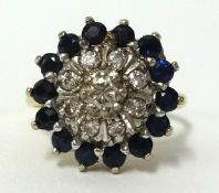 An 18ct sapphire and diamond cluster ring, finger size J.