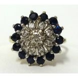 An 18ct sapphire and diamond cluster ring, finger size J.