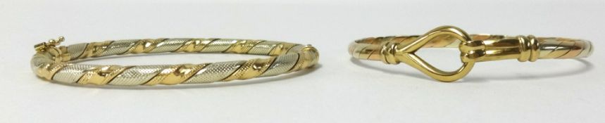A 9ct gold bangle and another yellow metal bangle (not hallmarked), approx 23gms total weight (2).