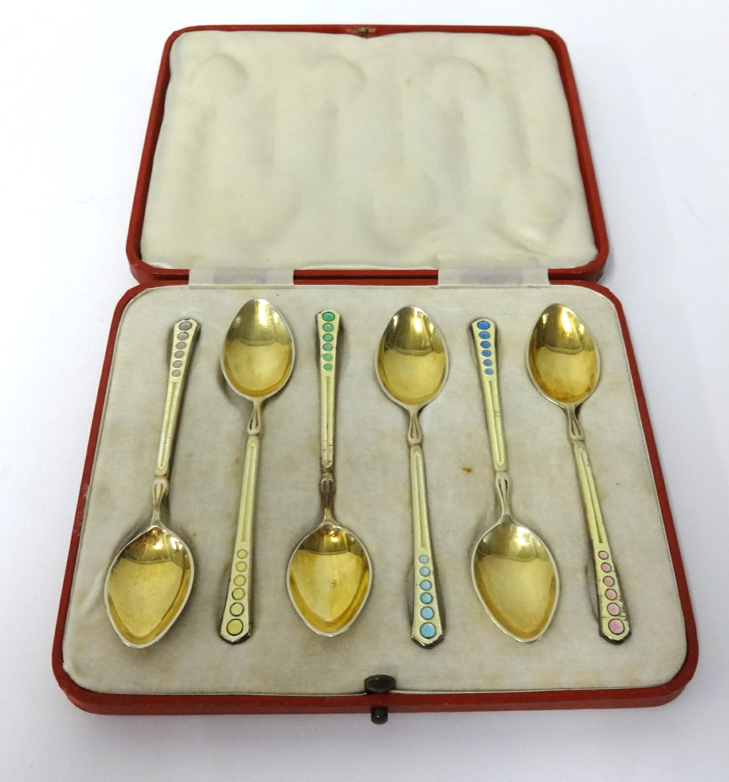 Set of six silver gilt and enamel tea spoons, 'T&S', in original fitted case.