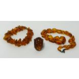 An amber bead necklace, approx 35.40gms together with an amber set ring (2).