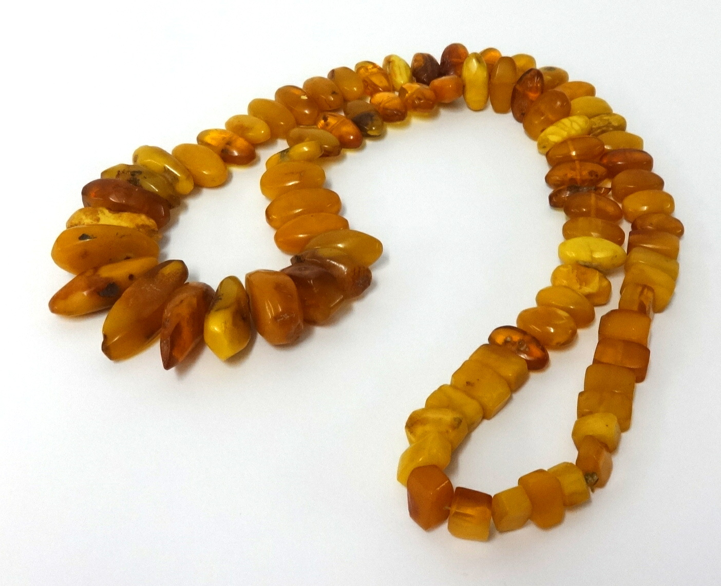 An amber necklace, approx 45cm long, various cuts, weight 150gms. - Image 2 of 2