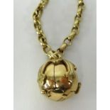 A 9ct gold Masonic ball pendant opening to reveal a cross engraved with various Masonic symbols,