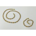 A 14k three coloured gold fancy link bracelet and similar necklace (18 inches long), approx 19.20