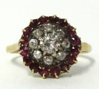 An antique diamond and ruby cluster ring set in yellow metal, (unhallmarked), diameter approx