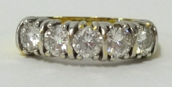 An 18ct five stone diamond ring, finger size O.