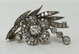 An impressive antique diamond brooch of spray flower form set with an arrangement of opal cut
