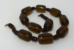 A dark brown amber style bead necklace, approx 106gms.