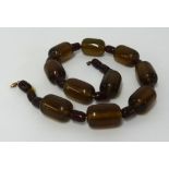 A dark brown amber style bead necklace, approx 106gms.