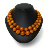 An amber double necklace, approx 81.70gms.