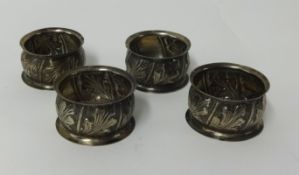 Set of four silver napkin rings with embossed design approx 50gms.