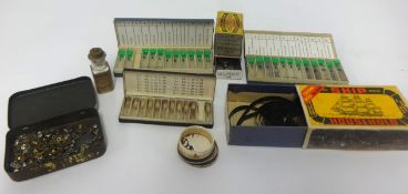 A quantity of two inch clock main springs, Gruen, polished screw and assortment of watch parts.