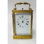 A 19th century gilt brass cased carriage clock, key wind movement, enamel dial with roman