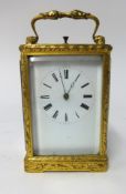 A 19th century gilt brass cased carriage clock, key wind movement, enamel dial with roman