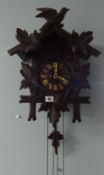 A German early 20th century dark oak cuckoo clock.