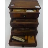 A small chest fitted with four drawers, various watchmaker components and small boxed tool set, U