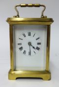 A French brass cased carriage clock, platform escapement, key wind, the white enamel dial set with