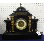 A Victorian black marble clock of architectural design with 8 day movement, key and gilt figure