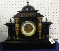 A Victorian black marble clock of architectural design with 8 day movement, key and gilt figure