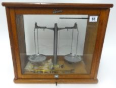 A set of Tower scales in glass cabinet.