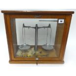 A set of Tower scales in glass cabinet.