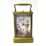 A brass cased carriage clock with three painted panels depicting a Dutch scene of river and