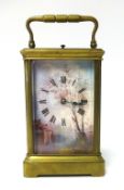 A brass cased carriage clock with three painted panels depicting a Dutch scene of river and