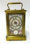 A 19th century French brass cased repeater and alarm carriage clock with porcelain dial and sides,