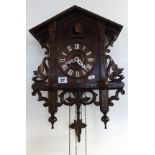 A Victorian oak and inlaid cuckoo clock.