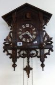 A Victorian oak and inlaid cuckoo clock.