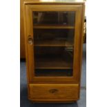 Ercol, a glass fronted cabinet.