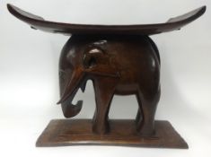 A carved wood elephant stool, height 49cm.