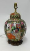 A modern Chinese porcelain ginger jar converted to a table lamp on carved wood stand, overall height