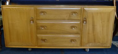 Ercol, a light elm sideboard, length 155cm, height 69cm, on ball castors.